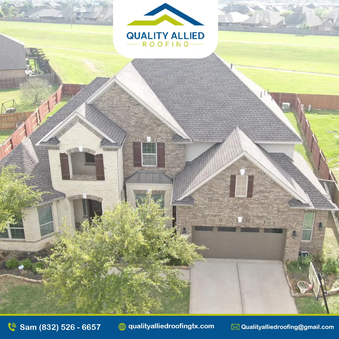 Aerial view of a house under construction with a red shingled roof and a metal roof extension, one of quality allied roofing at houston roofing project