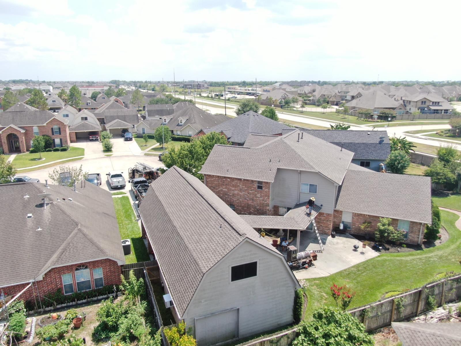 Aerial view of a completed residential shingle roof, photograph 1