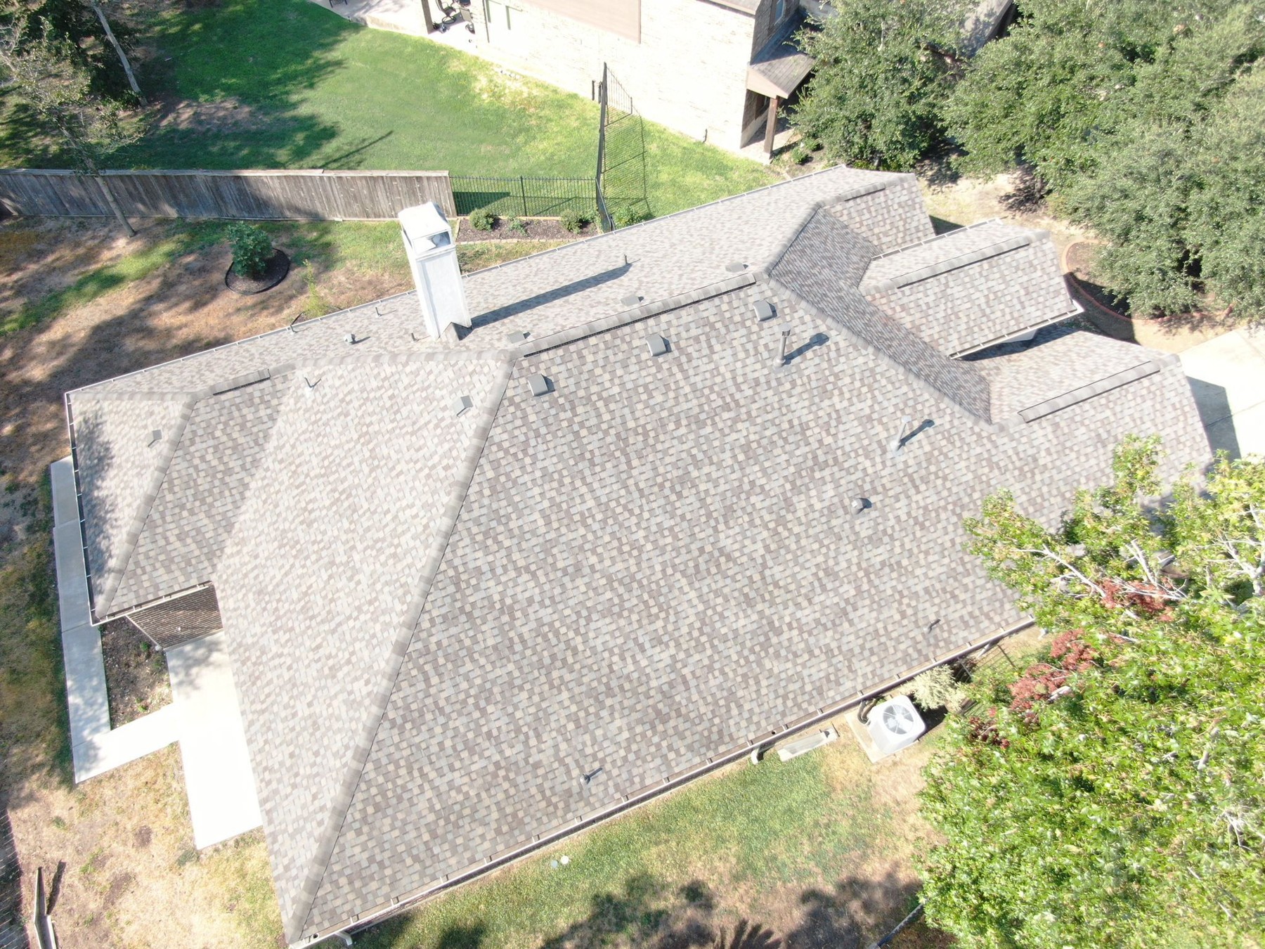 Aerial view of completed residential shingle roofing