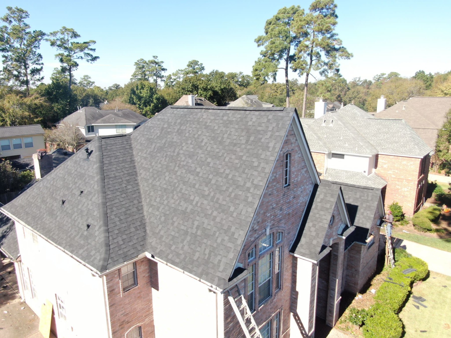 Aerial view of completed residential shingle roofing